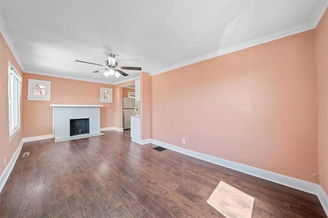 unfurnished living room featuring visible vents, baseboards, crown molding, and dark wood-type flooring