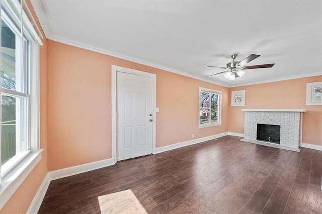 unfurnished living room featuring crown molding, ceiling fan, baseboards, a fireplace, and wood finished floors