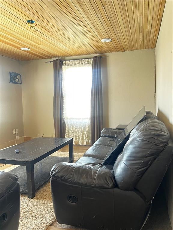 living room featuring wooden ceiling