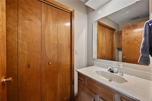 bathroom featuring vanity and visible vents