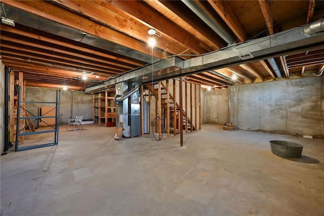 unfinished basement with stairway and heating unit