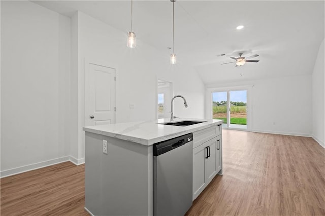 kitchen featuring open floor plan, dishwasher, light wood-style floors, and a sink