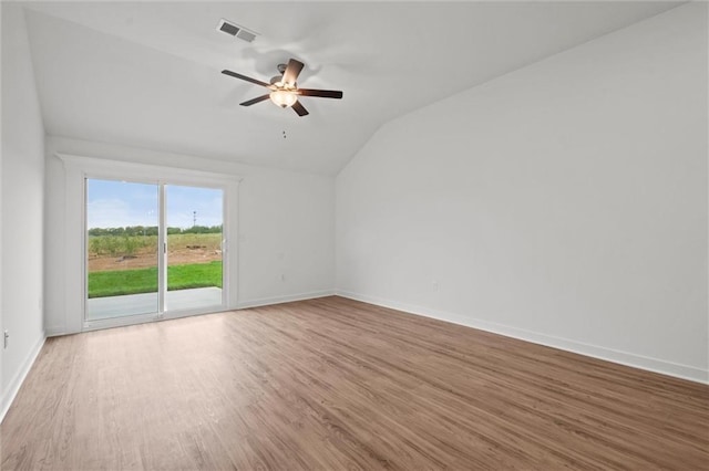 spare room featuring visible vents, baseboards, a ceiling fan, and wood finished floors