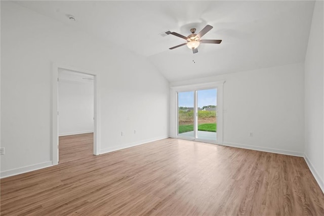 empty room with light wood-style flooring, baseboards, a ceiling fan, and vaulted ceiling