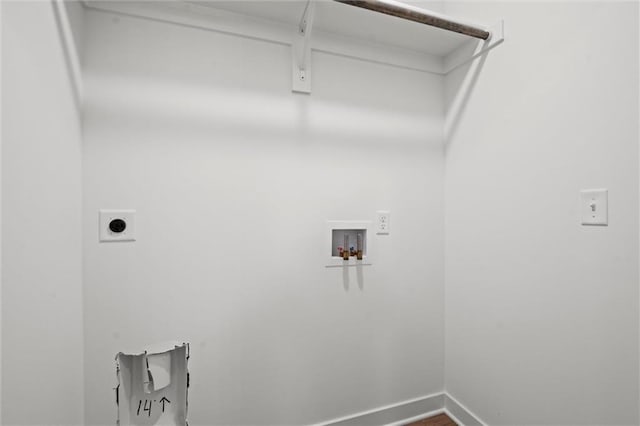 washroom with baseboards, hookup for an electric dryer, hookup for a washing machine, and laundry area