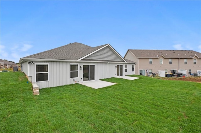 back of house featuring a yard and a patio area