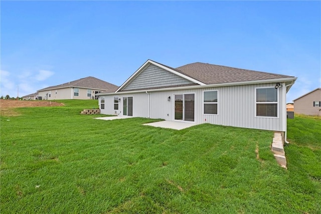 back of property with a patio and a yard