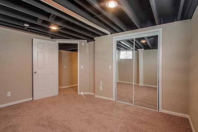 basement with carpet flooring and baseboards