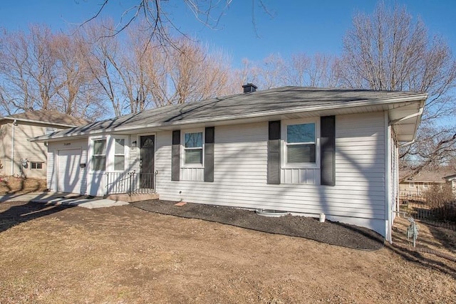 single story home with a shingled roof and a garage