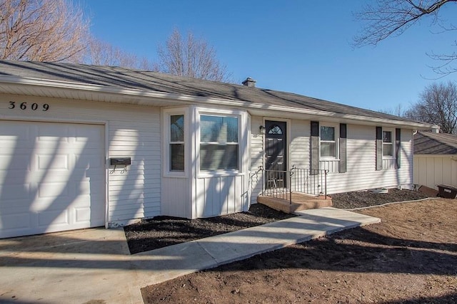 view of front of home with concrete driveway and a garage