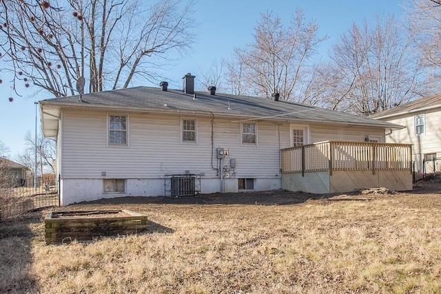 back of house with a yard and central AC