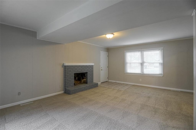 unfurnished living room featuring visible vents, baseboards, carpet, and ornamental molding