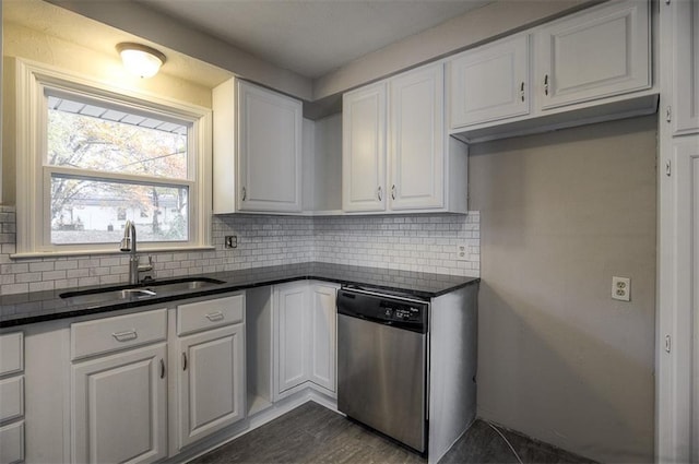 kitchen featuring a sink, backsplash, white cabinetry, and stainless steel dishwasher