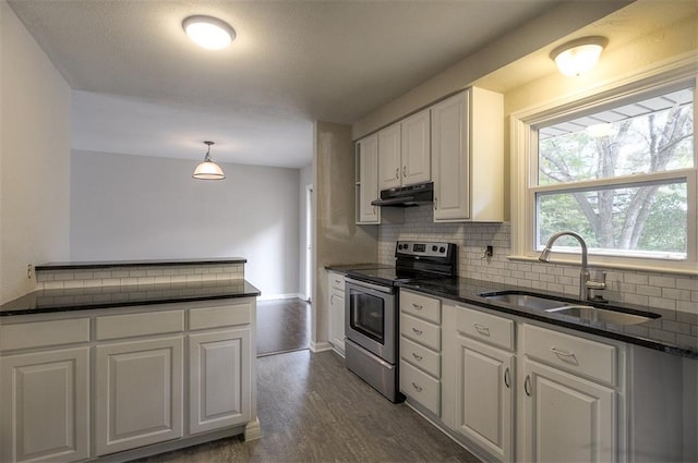 kitchen featuring under cabinet range hood, decorative backsplash, stainless steel electric range, white cabinets, and a sink