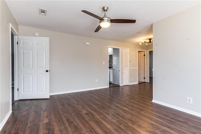 unfurnished room featuring visible vents, baseboards, wood finished floors, and a ceiling fan