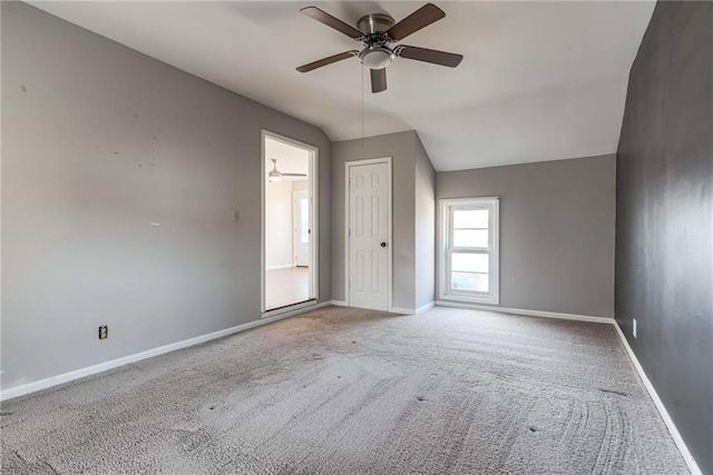 interior space featuring lofted ceiling, a ceiling fan, and baseboards