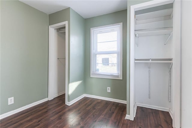 unfurnished bedroom featuring a closet, baseboards, and wood finished floors