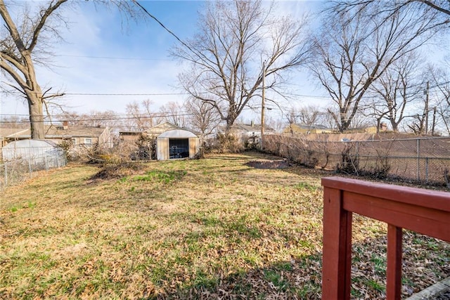 view of yard with a shed, an outdoor structure, and a fenced backyard