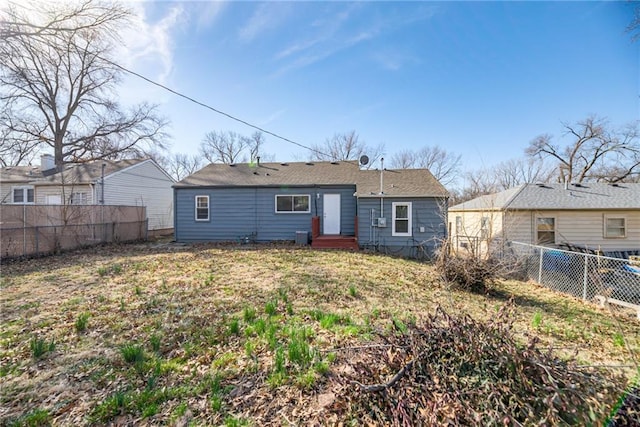 back of property featuring entry steps and a fenced backyard