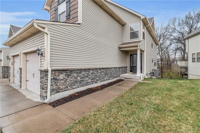 view of property exterior with a lawn, stone siding, central AC, concrete driveway, and a garage