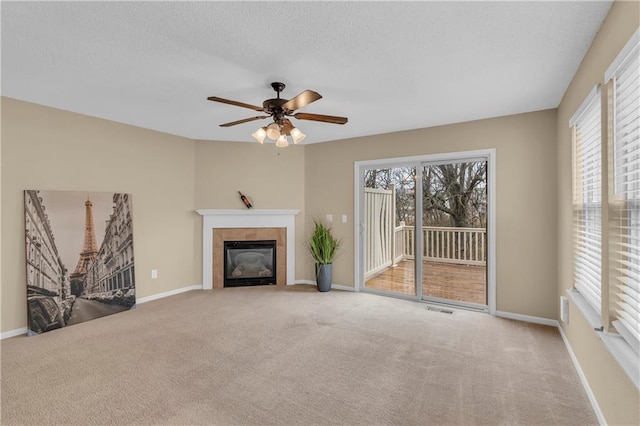 unfurnished living room with a healthy amount of sunlight, carpet floors, and a textured ceiling