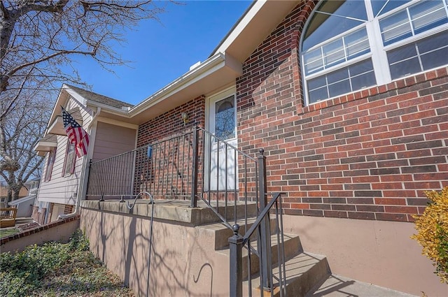 view of property exterior with brick siding