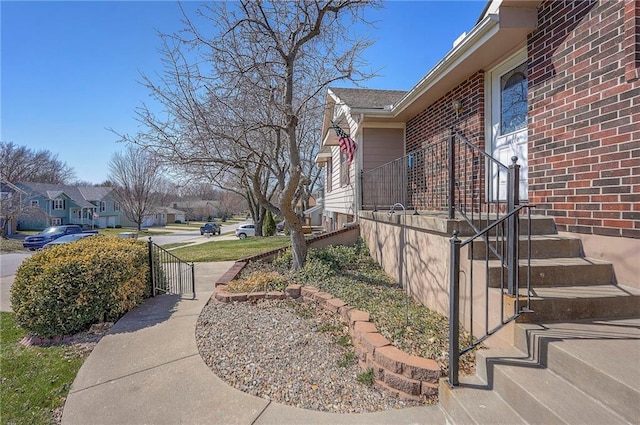 view of side of home with brick siding and a residential view