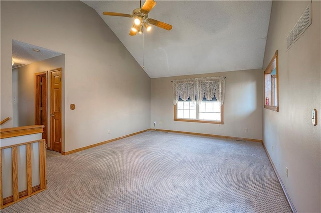 empty room with high vaulted ceiling, a ceiling fan, baseboards, and light carpet