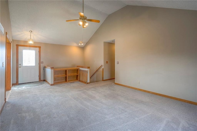 entrance foyer featuring high vaulted ceiling, light colored carpet, baseboards, and ceiling fan