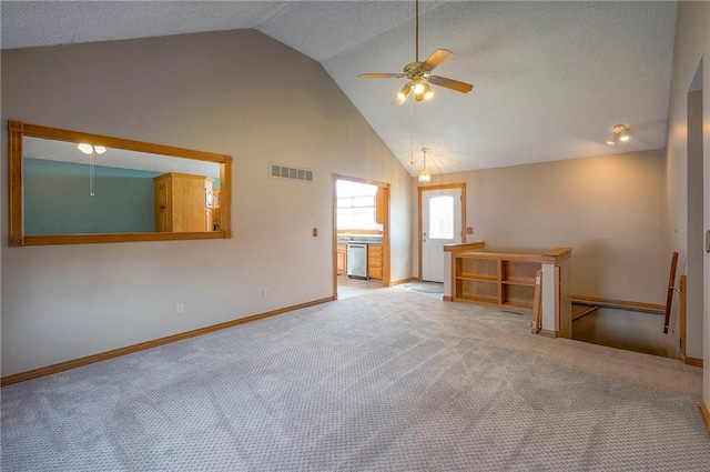 unfurnished living room featuring visible vents, high vaulted ceiling, a ceiling fan, carpet, and baseboards