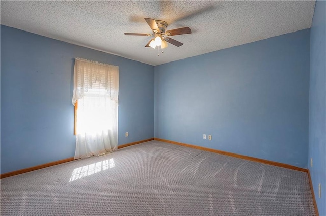 empty room featuring baseboards, a textured ceiling, ceiling fan, and carpet