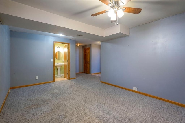 interior space with connected bathroom, baseboards, carpet floors, and a sink