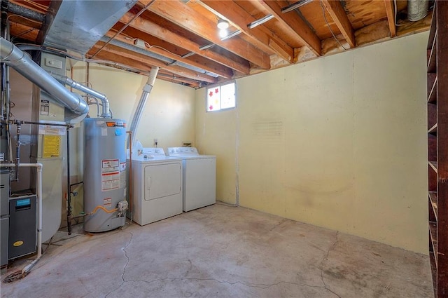 below grade area with washer and dryer, heating unit, and water heater