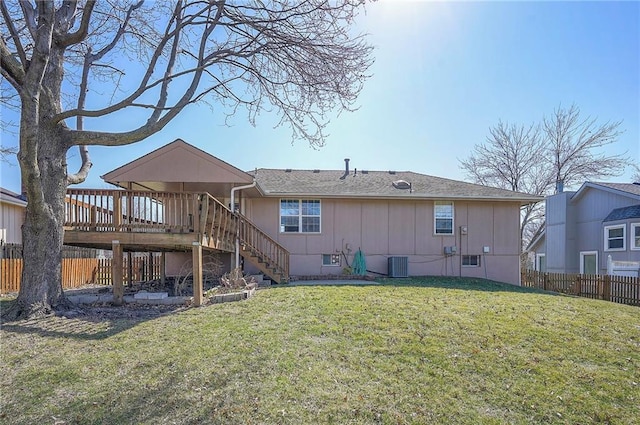 rear view of property with central air condition unit, fence, a yard, stairway, and a wooden deck