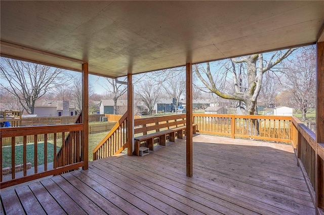 wooden deck with a residential view and fence