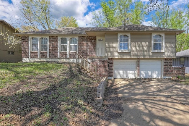 single story home with brick siding, a garage, and driveway