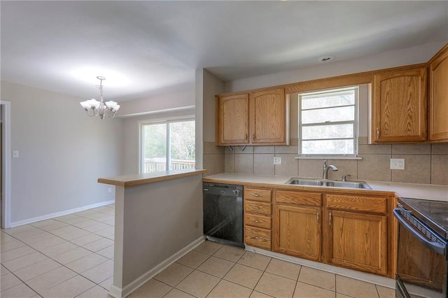 kitchen featuring black appliances, a sink, decorative backsplash, a chandelier, and healthy amount of natural light