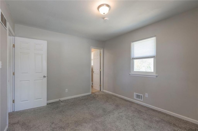 unfurnished bedroom featuring carpet and baseboards