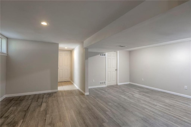 basement featuring wood finished floors, baseboards, and recessed lighting