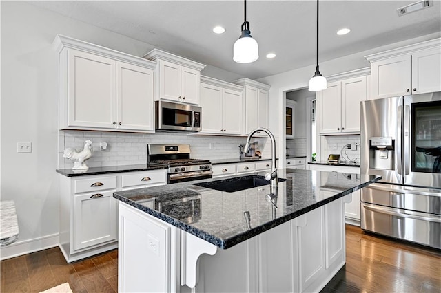 kitchen featuring dark wood finished floors, visible vents, appliances with stainless steel finishes, and a sink