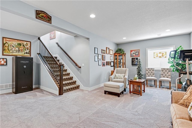 interior space featuring baseboards, recessed lighting, stairs, a textured ceiling, and light carpet