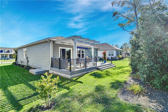 back of house featuring a lawn, a pergola, and a deck