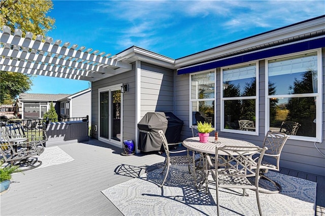 wooden deck featuring area for grilling, outdoor dining area, and a pergola