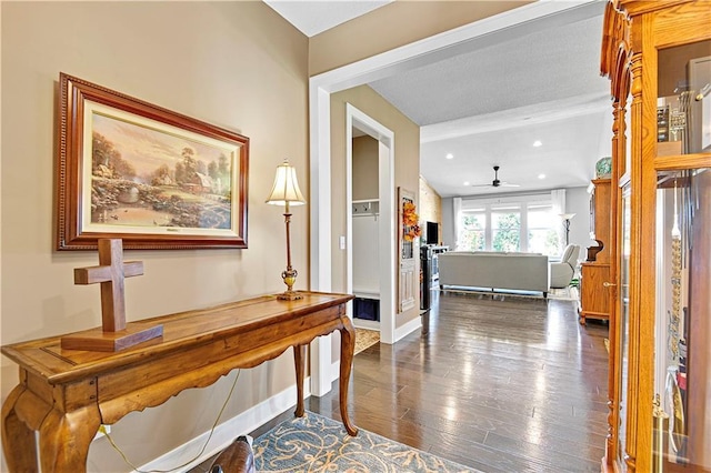 hall featuring recessed lighting, baseboards, and dark wood finished floors