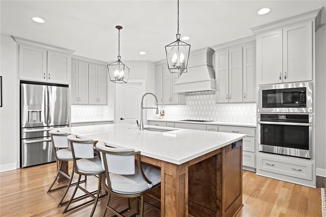 12745 N Larkspur Ln, Platte City, MO 64079 - kitchen with premium range hood, appliances with stainless steel finishes, and recessed lighting