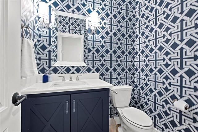 12745 N Larkspur Ln, Platte City, MO 64079 - half bathroom with wallpapered walls, toilet, and vanity