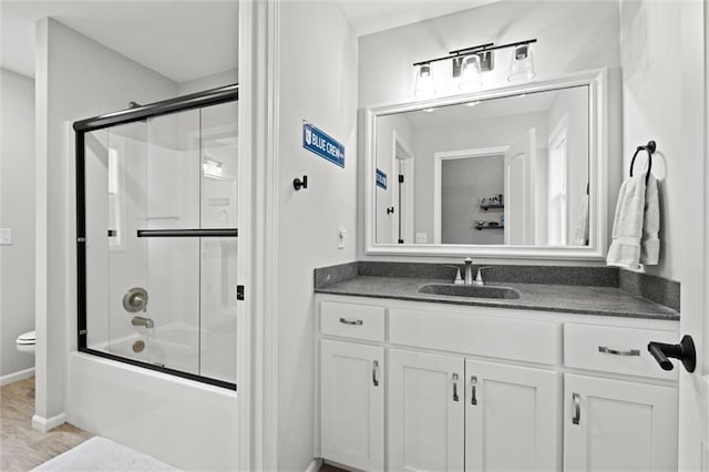12745 N Larkspur Ln, Platte City, MO 64079 - bathroom with baseboards, toilet, vanity, and combined bath / shower with glass door