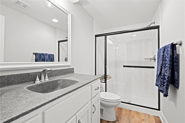 12745 N Larkspur Ln, Platte City, MO 64079 - bathroom with toilet, visible vents, wood finished floors, a shower stall, and vanity