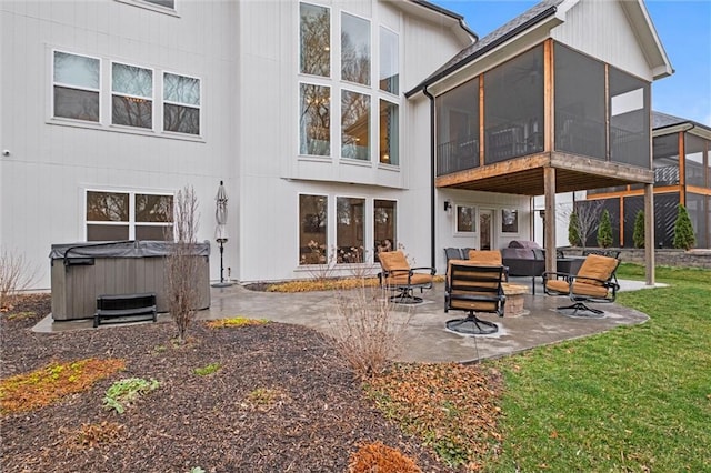 12745 N Larkspur Ln, Platte City, MO 64079 - rear view of property featuring a lawn, a hot tub, a sunroom, a patio, and an outdoor living space
