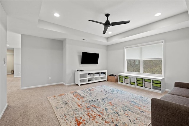 12745 N Larkspur Ln, Platte City, MO 64079 - living room with a ceiling fan, carpet floors, a tray ceiling, baseboards, and recessed lighting